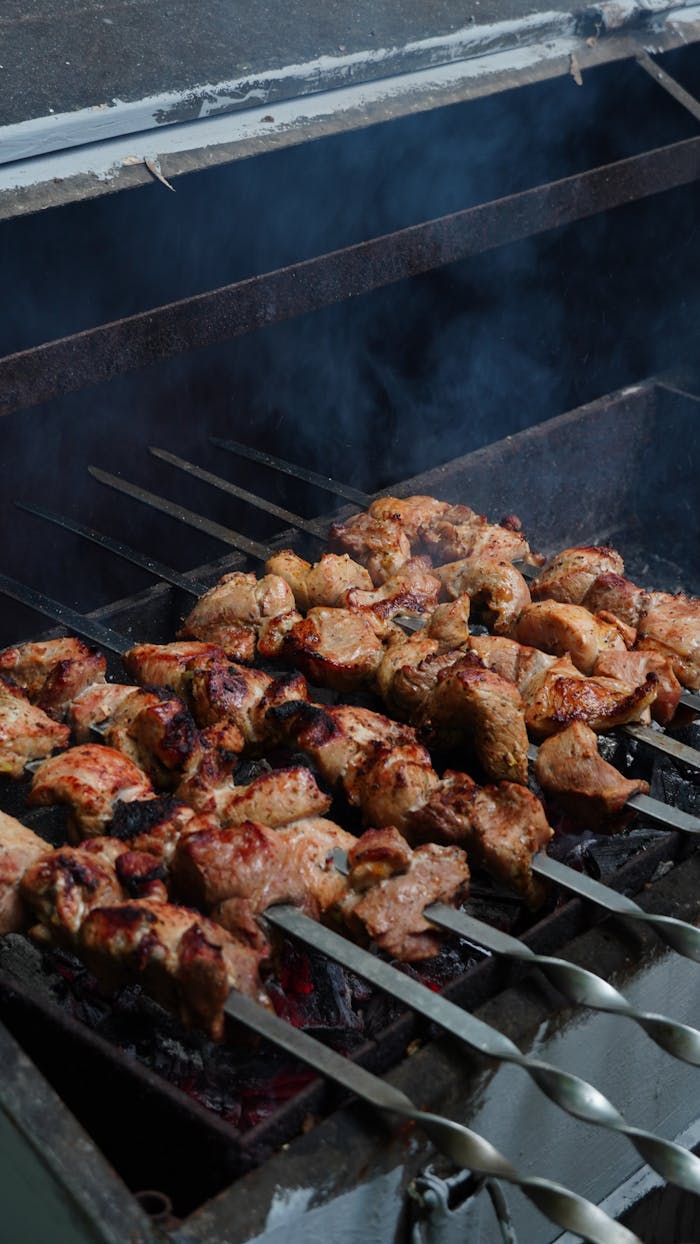 why-choose-us Juicy chicken skewers grilling over hot coals with smoke rising, perfect summer barbecue.